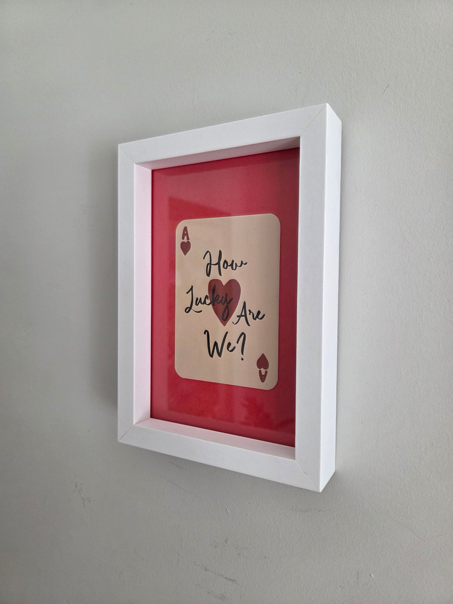 FRAMED How Lucky Are We? Playing Card Art Print - White Frame with Red Mount