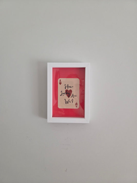 FRAMED How Lucky Are We? Playing Card Art Print - White Frame with Red Mount