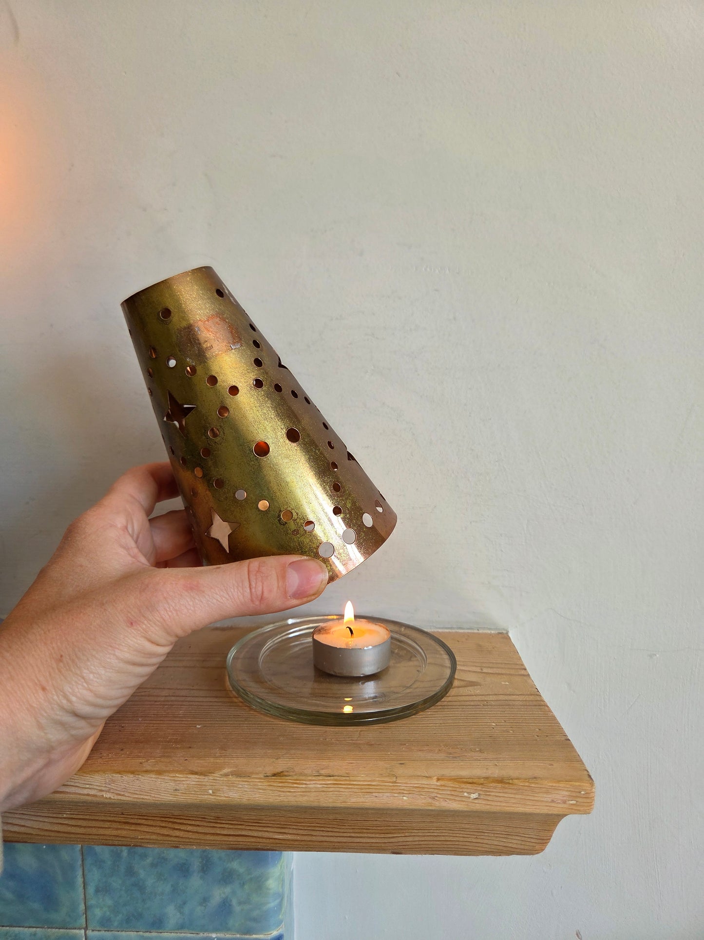Brass Coloured Tealight Shade with Star Cutouts on Glass Candle Plate